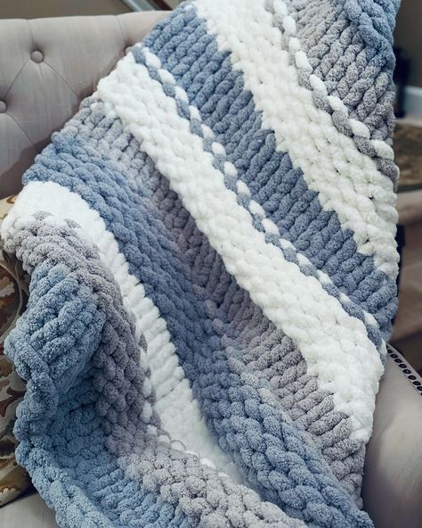 A chunky baby  blanket is a type of blanket that is known for its thick, bulky, and cozy texture. It is typically made using chunky  yarn, resulting in a warm and luxurious feel. Chunky baby  blankets are popular for their visual appeal and the comforting weight they provide. They are often used as decorative pieces or for keeping warm during colder seasons. Chunky Knit Blanket Display, Knitted Baby Boy Blankets, Things To Crochet With Blue Yarn, Crochet Blankets For Boys, Chunky Yarn Blankets, Christmas Chunky Knit Blanket, Chunky Blanket Color Ideas, Hand Knit Blanket Pattern, Chunky Knit Blanket Pattern Color Combos