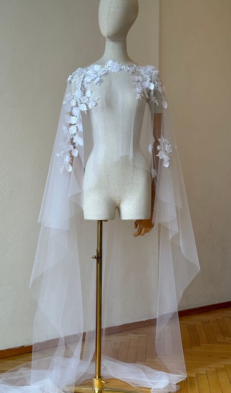 Short lace cape,bridal cape, floral wedding cape, bride cape, floor length veil, capelet, wedding cape, custom cape/bespoke cape Handcrafted with dedicated lace and illusion tulle. Materials: lace, illusion tulle. Colour: white  The cape can be made at your preferable measurements. Veil care: hang and steam. If you want to order a long veil write me please. I will gladly prepare a personal wedding cape or other decoration for you. You can send me a photo of a example you would like to recreate o Unique Wedding Veil Ideas, Bride Cape, Half Cape, Winter Wedding Cape, Wedding Dress With Cape, Floor Length Veil, Lace Capelet, Cape Veil, Upcycled Accessories