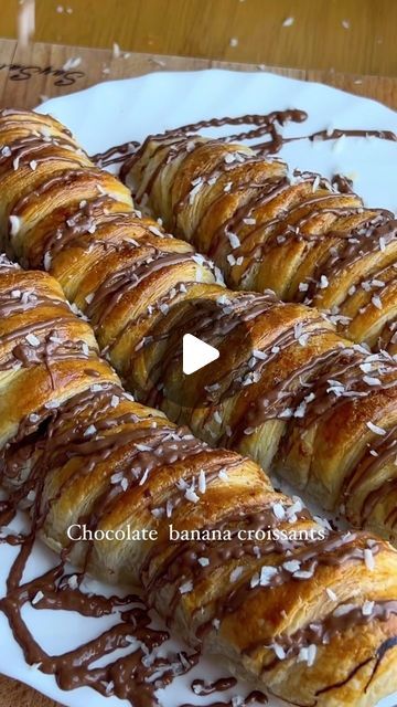 Dawn Dean on Instagram: "Ingredients:  Chocolate Banana Boats Wrapped in Puff Pastry Croissant  Ingredients: - Puff pastry: 400 grams - Bananas (ripe): 3 pieces - Chocolate: 100 grams (Kinder or your preferred type) - An egg (for egg wash) - Chocolate for decoration  Directions:  1. Preheat the oven:  Preheat your oven to 200°C (400°F).  2. Prepare the puff pastry:  - Roll out the puff pastry on a lightly floured surface to about 1/8 inch thickness.  - Cut the puff pastry into long strips, about 1/2 inch wide.  3. Prepare the bananas:  - Peel the bananas.  - Cut out a small trough in the center of each banana using a spoon, being careful not to break the banana.  4. Add the chocolate:  - Place pieces of chocolate in the trough of each banana half. Ensure the chocolate is spread evenly.  5. Essen, Chocolate Banana Croissant, Banana Chocolate Puff Pastry, Banana Puff Pastry Dessert, Banana Croissant, Banana Pastry, Puff Pastry Croissant, Banana Wrap, Pastry Croissant