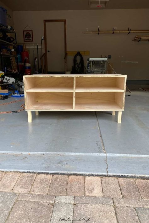 My daughter recently moved into her very first college apartment and she needed some new furniture built. One of those pieces was a TV stand. Today I am going to share with you how I built this DIY TV stand. Tv Stand With Shelf, Diy Tv Stand With Shelves, Diy 75 Inch Tv Stand, Tv Stand Homemade, How To Make A Tv Stand Diy, Easy Tv Stand Diy, Diy Boho Tv Stand, Diy Entertainment Stand, 2x4 Tv Stand