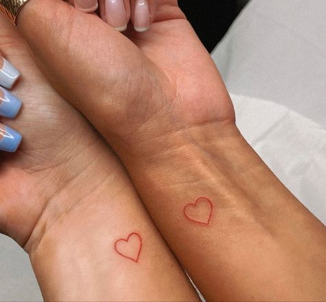 Red Heart On Wrist Tattoo, Matching Red Heart Tattoos, Hand Tattoos For Women Heart, Heart Wrist Tattoos For Women, Red Hearts Tattoo, Heart Tattoo Matching, Red Wrist Tattoo, Mini Red Tattoo, Heart Matching Tattoos