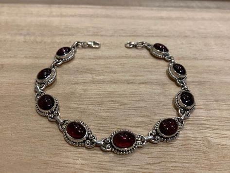 Lovely garnet and sterling silver bracelet. The bracelet has 9 individual garnet in an oval shape.  The bracelet measure 21 cm long and it is almost 0.8 cm wide. The bracelet can be  easily  adjusted from 21 cm to 17 cm.  The high quality of our stones is what it makes this bracelet so precious.  A perfect present for her on any occasion St Valentine Day, Birthday, Anniversary, Travelling or Christmas. Your bracelet will be pack in our lovely Kallpa bag. If the destination is outside UK the pack St Valentine, Edgy Jewelry, Red Bracelet, Present For Her, Garnet Bracelet, Dope Jewelry, Red Bracelets, Garnet Jewelry, Bracelet Chain