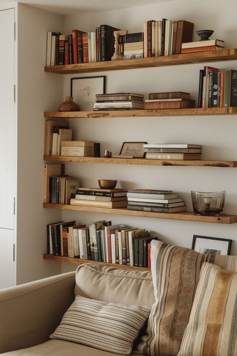 Embrace modernity in your home library with sleek shelving unit designs! Discover chic styles that elevate your reading space while keeping it organized. Let’s bring your home library into the 21st century! #HomeLibrary #SleekDesigns #ModernLiving Open Shelves Library, Floating Shelves Reading Room, Living Room Open Shelves, Bookshelves With Brackets, Free Floating Bookshelves, Wooden Bookshelves In Living Room, Living Room Floating Bookshelves, Aesthetic Book Shelves Ideas, Library Floating Shelves