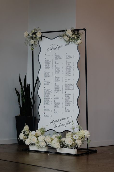 Modern black and white seating chart wtih curvy edge and white flowers baby's breath industrial wedding at Glass House Seating Chart Wedding Black And White, Black And White Wedding Seating Chart, Black Seating Chart Wedding, Unique Seating Chart Ideas, Black Wedding Seating Chart, Black And White Seating Chart, Diy Seating Chart Wedding, White Seating Chart, Modern Seating Chart