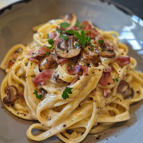 Recipe for Tagliatelle Carbonara with Mushrooms Ingredients: 400g tagliatelle 200g pancetta or bacon, diced 200g mushrooms, sliced 3 large eggs 100g grated Parmesan cheese 2 cloves garlic, minced 1/2 cup heavy cream (optional for creamier texture) Salt and freshly ground black pepper to taste 2 tablespoons olive oil Fresh parsley, chopped (for garnish) Instructions: Cook the Pasta: Bring a large pot of salted water to a boil. Add the tagliatelle and cook according to the package instructions... Mushroom Bacon Pasta, Pasta With Sauce, Tagliatelle Carbonara, Pasta Tagliatelle, Tagliatelle Pasta, Mushroom Pasta, Western Food, Yummy Comfort Food, Quick Dinner Recipes