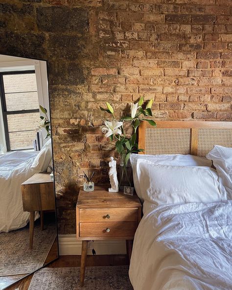 Small nyc apartment with exposed brick. White and clean decor. Brick Interior Apartment, Brick Boho Bedroom, Apartment Decorating Brick Wall, New York Exposed Brick Apartment, New York City Apartment Studio Brick Walls, Bedroom With Red Brick Wall, Bedroom Ideas Exposed Brick, Exposed Brick Loft Bedroom, Brick Studio Apartment Ideas