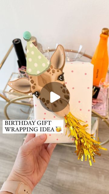 Shelby | Gift-in-a-Box Guide on Instagram: "YOU’RE NOT READY FOR HOW CUTE! 🥳🎁🦒  Comment ZHUZH for the animal garland & everything else I used to wrap this gift!   This is a new way to use the cute party horns for gift wrapping! Just grab a cute animal garland / cutout and add the blower using hot glue or foam tape to secure it   The garland came with 20 die cut animals and the party horns come in a pack of 6 so you can easily rinse and repeat this same method for a bunch of gifts!   I also ended up adding some letter beads to the top right corner for the name which made it even cuter  An easy way to create a Pinterest-esque gift! ✨  What should we name him?!?  #birthday #birthdaygifts #bdaygift #birthdaygiftideas #giftwrappingideas #giftwrapping #giftwrappinginspiration #giftwrappingins Birthday Packaging Ideas, Unicorn Gift Wrapping Ideas, Animal Wrapping Paper, Stuffed Animal Gift Wrapping Ideas, Animal Wrapping Ideas, Fun Ways To Wrap Birthday Gifts, Animal Gift Wrapping Ideas, Fun Birthday Wrapping Ideas, Present Wrapping Ideas Birthday