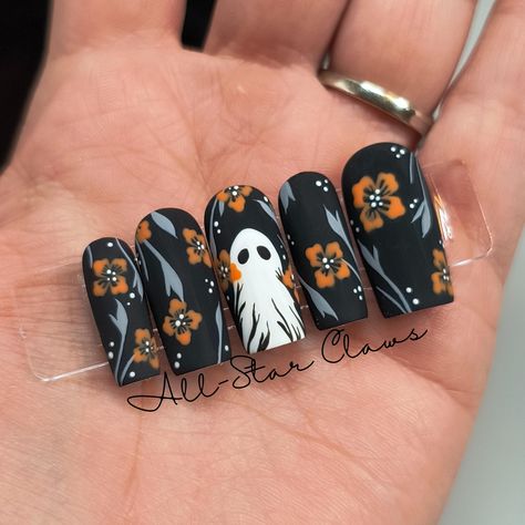 All nails have a black gel base color with grey vine\leaves orange flowers and white dots. The middle nail has a white ghost plus the flower and vine design. All nails have a matte top coat finish. All nails have a builder gel layer. Available in different shapes and lengths. **Please measure your nails for the XXL length and select "XXL Custom Sizes" then send me your measurements.** Each order comes with a nail prep kit which includes nail glue, nail adhesive tabs, nail file, buffer, cuticle stick, alcohol wipes, and instructions. Please don't hesitate to ask me any questions. Halloween Nail Designs Matte, Ghost Fall Nails, Matte Black Wedding Nails, Black Nails With Pumpkin, Halloween Stamped Nails, Professional Halloween Nails, Ghost Flower Nails, Matte Halloween Nail Designs, Halloween Spooky Nails