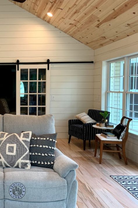 Scott and Amy painted their living room's shiplap walls white, and left the ceiling unfinished to add extra warmth to the space. It is certainly a lovely and welcoming room!!! Loving the ambrosia maple flooring as well! So much character! White Walls Wood Ceiling Cabin, Shiplap In Family Room, Shiplap On Vaulted Wall, White Plank Walls Living Room, Cedar Ceiling Shiplap Walls, Shiplapped Living Room, Sunroom Shiplap Walls, Living Room Wood Ceiling Ideas, White Walls Pine Trim