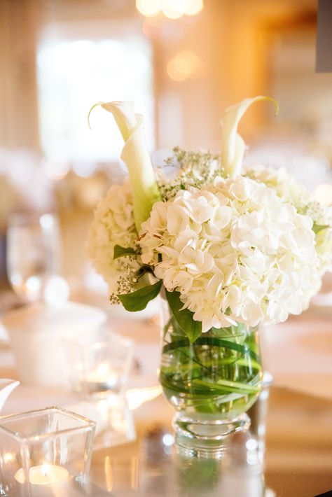 White Flower Arrangements with Hydrangeas and Calla Lilies Lily Hydrangea Arrangement, Flower Arrangements With Hydrangeas, Arrangements With Hydrangeas, Calla Lily Wedding Centerpiece, August Wedding Flowers, Calla Lily Centerpieces, Calla Flower, Lilies White, Calla Lily Wedding