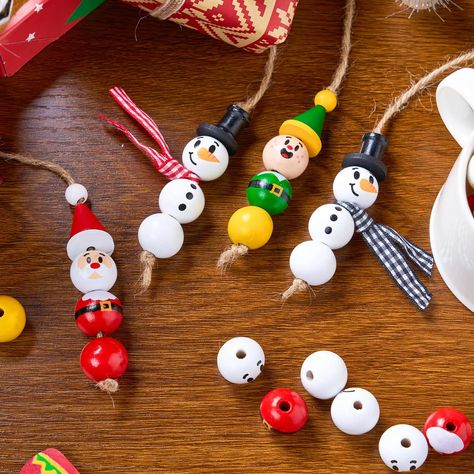 SUPER VALUE PACK. The perfect way to add a personal touch to your holiday decorations! This crafts is packed with everything you need to create 30 charming ornaments, featuring three beloved characters: Santa santa, Snowman, and Elf. Let your imagination run wild with these 90 large wooden beads, 30 wooden discs, 20 small wooden beads, 10 dumbbell wood beads, 20 triangle wood beads, and three bundles of festive ribbons and twine. CREATE SPECIAL HOLIDAY MEMORIES. Get ready for hours of creative f Christmas Crafts With Wooden Beads, Wood Bead Snowman Ornaments Diy, Simple Wooden Ornaments, Wooden Bead Ornaments Christmas, Silicone Bead Christmas Ornaments, Wood Bead Christmas Ornaments Diy, Wood Ball Crafts, Christmas Wooden Bead Crafts, Wooden Bead Christmas Crafts