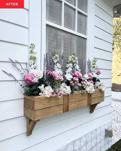 A wooden flower box on the side of a white house Flower Boxes In Front Of House, Flower Box Under Window, White House Window Boxes, Under Window Flower Boxes, Fake Flower Boxes Window, Diy Window Flower Boxes, Window Garden Outdoor, Outdoor Window Planter Boxes, Under Window Planter Boxes