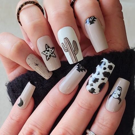 If you're a big fan of animal-inspired manicures, then brown cow print nails might be just what you need for your next nail design project! Includes beautiful brown nail polish designs for short nails, long nails, coffin nails, almond nails and many other options. Black And Gold Cow Print Nails, Current Nail Designs, Western Print Nails, Black Western Nail Designs, Fall Cowgirl Nails, Cowprint Nail Design Almond, Almond Shape Western Nails, Rodeo Nails Designs Westerns, Arizona Nail Ideas