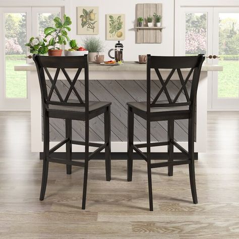 Sitting at the perfect height for kitchen islands, breakfast bars, and pub tables, this stool has a leg up on other seating options. Crafted from solid wood, it showcases a neutral hue sure to blend in with any color palette you pick, and a double X design on its back for a traditional look. Plus, there's a convenient footrest to keep you comfortable while you linger over some evening snacks or your morning coffee. Best of all, this stool arrives in a set of two. Kitchen Stools With Back, Chairs For Kitchen Island, Farmhouse Bar Stools, Pub Tables, Tall Bar Stools, Bar Stools Kitchen Island, Dining Table Dimensions, Wooden Counter, Bar Stools With Backs