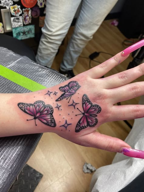 Purple Butterfly Hand Tattoo, Pink Butterflies Tattoo, Ladies Hand Tattoos, Butterfly Hand Tattoo For Women, Butterfly Hand Tattoos, Pink Butterfly Tattoo, On Hand Tattoo, Heart Tattoo Ideas, Pink Purple Butterfly