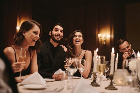 Group of socialites sitting around a dining table at a party. High society people having gala dinner party. Malta Restaurant, Festive Photoshoot, Luxurious Dinner, April Fashion, Photoshoot Moodboard, Filler Photos, Private Dinner, Elegant Food, Host Dinner Party