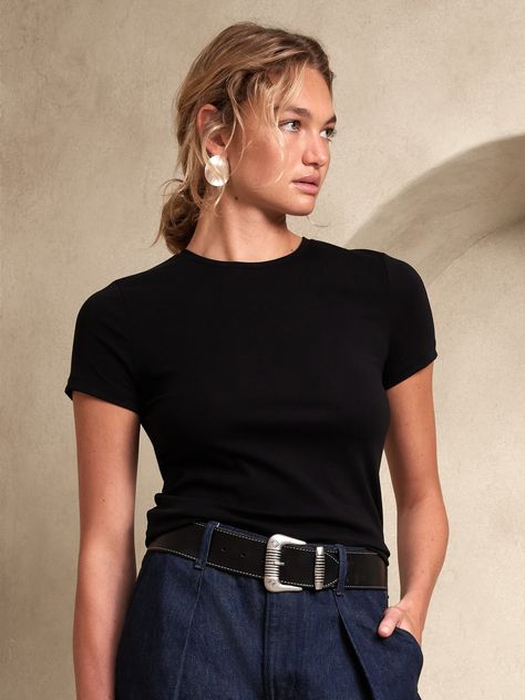 An essential in modern proportions, this shrunken tee is a sleek mini, made of our specially crafted Refined cotton jersey, a luxurious fabric, high in stretch so it moves with you and specially washed for unparralleled softness.  FITTED: Stretches to fit.  Crew neck.  Straight hem.  Fitted.  Short sleeves.  Hip length.  Body length (size S): Regular 23. 5" Sleeve length from center back: Regular 12" Model: Size S, 5'10" (178cm). Black, Banana Republic, Luxurious Fabric, Crew Neck, Fabric, T Shirt