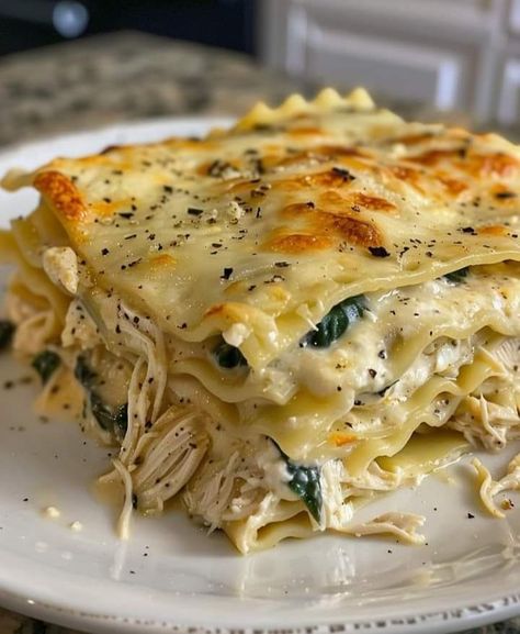 Creamy Chicken Lasagna with White Sauce  Ingredients  9 lasagna noodles 2 cups cooked, shredded chicken breast 2 cups ricotta cheese 2 cups shredded mozzarella cheese 1 cup grated Parmesan cheese 1 cup fresh spinach, chopped 3 cloves garlic, minced 1 small onion, finely chopped 2 tablespoons olive oil 4 cups milk 4 tablespoons butter 1/4 cup all-purpose flour 1/2 teaspoon ground nutmeg Salt and pepper to taste  Instructions  Prepare the Noodles: Cook the lasagna noodles according to package instructions. Drain and set aside. Make the White Sauce: In a large saucepan, melt the butter over medium heat. Add the minced garlic and chopped onion, sautéing until fragrant and translucent. Stir in the flour, cooking for about 1 minute until it forms a paste. Gradually whisk in the milk, continuing Creamy Chicken Lasagna, Lasagna With White Sauce, Chicken Lasagna Recipe, Grandma Cooking, Lasagna Noodles, Chicken Lasagna, Pasta Dinner Recipes, White Sauce, Lasagna Recipe