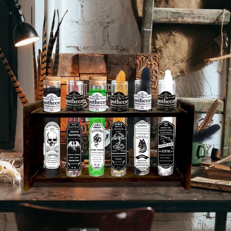 PRICES MAY VARY. Halloween Apothecary Potion Set: includes 6 test tube potion vials with corks, 1 apothecary rack, 6 black & white witch's labels, 2 colors and 4 different colors of feathers, adding to the mysterious atmosphere of the witch's apothecary bottles. The combination of magic potion test tubes and apothecary shelf is perfect for halloween decorations. Witch Theme Design: The sticker labels on these witches potion bottles are related to classic Halloween horror elements such as black c Witch Theme Decorations, Potions Halloween Decor, Halloween Potion Station, Halloween Apothecary Display, Halloween Potion Bottles Display, Potions Bar Halloween, Fake Halloween Potions, Witchy Halloween Decor, Mad Scientist Halloween