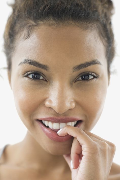 Close-up portrait of smiling woman biting nails Stop Biting Your Nails, Touching Face, Biting Nails, Red Eyebrows, How To Wear Headbands, Nails Products, Prom Nails Red, Nose Picking, Nail Care Tips