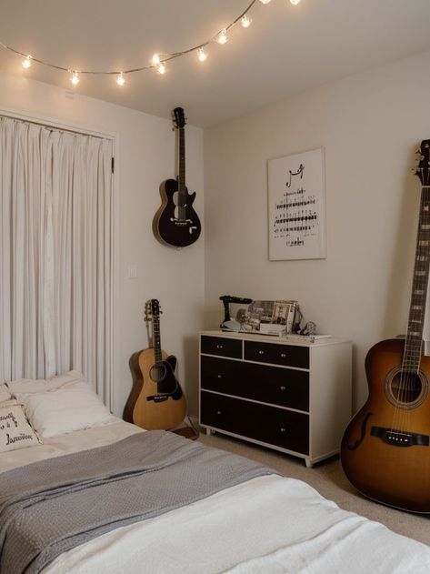 Create a music-themed bedroom aesthetic using a vinyl record as a unique wall art piece and a guitar as a decorative element. Hang string lights to create a whimsical vibe, and incorporate musical notes or lyrics as decals on the walls. Bedroom Music Studio Aesthetic, Music Lover Bedroom, Couples Room, Music Themed Bedroom, Music Bedroom, Student Bedroom, Neutral Bedrooms, Music Room Decor