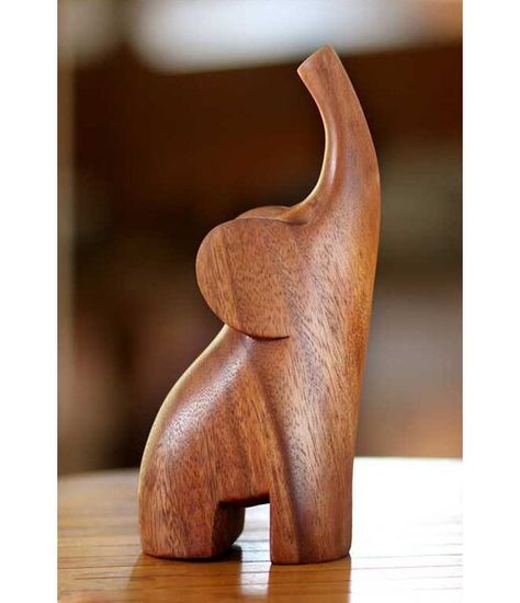 From Made Wirata, this sleek figurine distills the essence of the elephant in a modern figurine. With its trunk raised in a joyous trumpet, the forest creature triumphs over the challenges of its habitat. Art Sculpture En Bois, Baby Elefant, Wooden Elephant, Elephant Sculpture, Wood Carving Designs, Wood Carving Patterns, Elephant Figurines, Carving Designs, Buy Wood