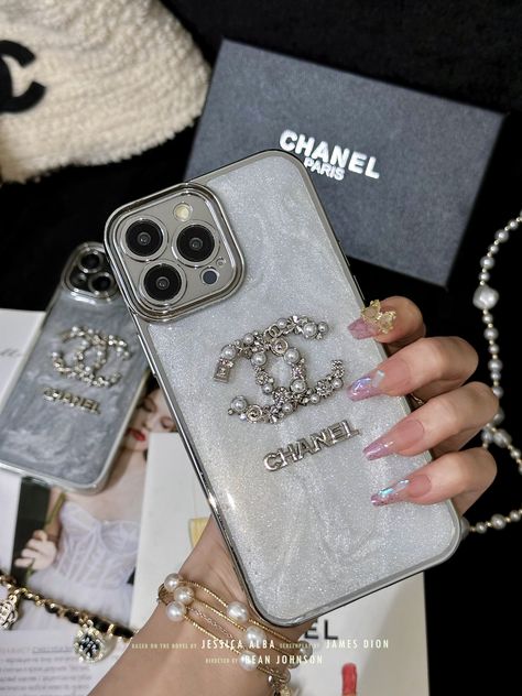 Chanel Letter Logo Plating: Embellished with the iconic Chanel letter logo in premium plating, this phone case exudes luxury and sophistication, making a bold fashion statement. Drop Protection Design: Engineered with drop protection in mind, this case offers reliable defense against impacts and accidental drops, safeguarding your phone from damage. Premium Material Construction: Crafted from high-quality materials, this case ensures durability and longevity, providing long-lasting protection for your phone while maintaining its stylish appearance. Precise Fit and Functionality: Tailored to fit your phone model precisely, this case allows easy access to all ports, buttons, and features, ensuring seamless functionality without compromising on style. Fashionable and Functional: More than jus Coco Chanel Phone Case, Phone Case Jewelry, Chrome Hearts Phone Case, Iphone Case Decorations, Chanel Letter, Chanel Phone Case, Chanel Iphone Case, Diy Phone Case Design, Designer Phone Cases