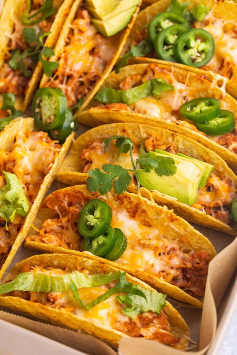 Baked chicken tacos are THE perfect taco night recipe. Quick and oh-so-easy, hard taco shells are stuffed with seasoned, shredded chicken, refried beans, tangy salsa, and shredded cheese, then baked until warm, melty, and deliciously crunchy. Seasoned Shredded Chicken, Taco Shell Recipe, Crunchy Taco Shells, Shells Stuffed, Hard Shell Tacos, Baked Chicken Tacos, Shredded Chicken Tacos, Taco Shells, Taco Ingredients