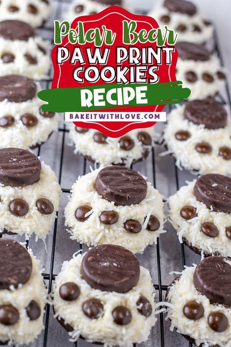 An overhead shot of rows of white, round, coconut covered cookies topped with chocolate candies to make a paw print. Polar Bear Paw Print, Paw Print Cookies, Homemade Vanilla Frosting, Polar Bear Paw, Paw Print Christmas, Paw Cookies, Cookie Platters, Winter Dessert, Winter Cookies