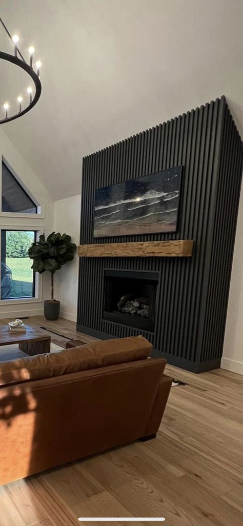 Black Wood Panel Fireplace Wall, Black Fireplace And Wall, Modern Wood Accent Wall Living Room, Wall Behind Fireplace Ideas, Fluted Fireplace Wall, Black Wall Living Room Ideas, Fluted Wood Fireplace, Moody Mediterranean, Wood Panel Fireplace Wall