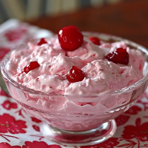 Step into a world of whimsy and delight with Pink Cherry Jello Fluff, a dessert that's as fun to make as it is to eat. This light and airy treat combines the sweet tanginess of cherry Jello with creamy whipped topping and fluffy marshmallows, all punctuated by the juicy burst of cherry pieces. Perfect for gatherings, celebrations, or as a cheerful pick-me-up, this dessert not only captivates with its playful pink hue but also enchants with its blend of textures and flavors. Easy to prepare and i Pink Cherry Jello Fluff, Pink Fluff Recipe, Cherry Jello Fluff, Jello Mouse, Pink Jello Salad, Jello Cool Whip Dessert, Jello Fluff Recipes, Jello Cream Cheese Dessert, Pink Fluff Salad