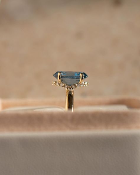 If you’re wondering what that gorgeous centre stone is, it’s a 2ct, oval blue spinel 💙 For even further flare, we have a stunning curved hidden moissanite halo Details: - 2ct oval blue spinel - 20x round moissanites - 10k yellow gold - 2.3mm wide shank #engagementringdesign #customengagementring #spinelengagementring #nz #ovalengagementring #aus #engagementringideas Spinel Engagement Rings, Blue Spinel, Classic Engagement, Classic Engagement Rings, Engagement Rings Oval, Fantasy Jewelry, Custom Engagement Ring, Designer Engagement Rings, Halo