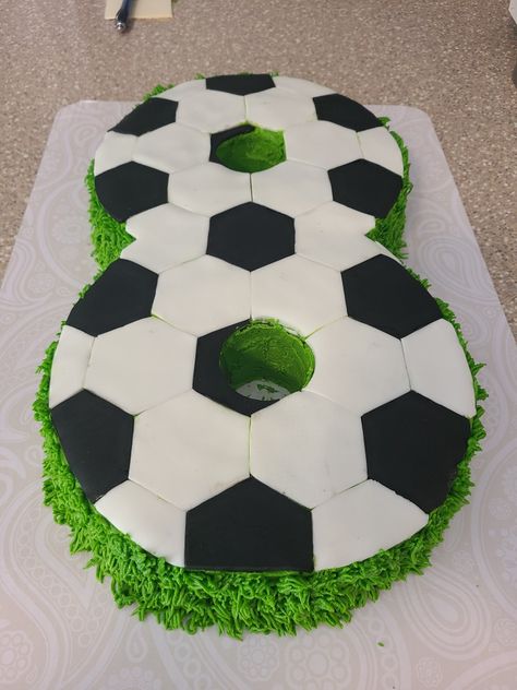 Birthday cake. Number eight with soccer print on top and grass along sides. Buttercream and fondant Soccer Cake Rectangle, Easy Soccer Birthday Cake, Number 8 Football Cake, Soccer Sheet Cake, Soccer Cakes For Boys, Soccer Cake Ideas For Boys, Soccer Field Cake, Soccer Cake Ideas, Number 8 Cake