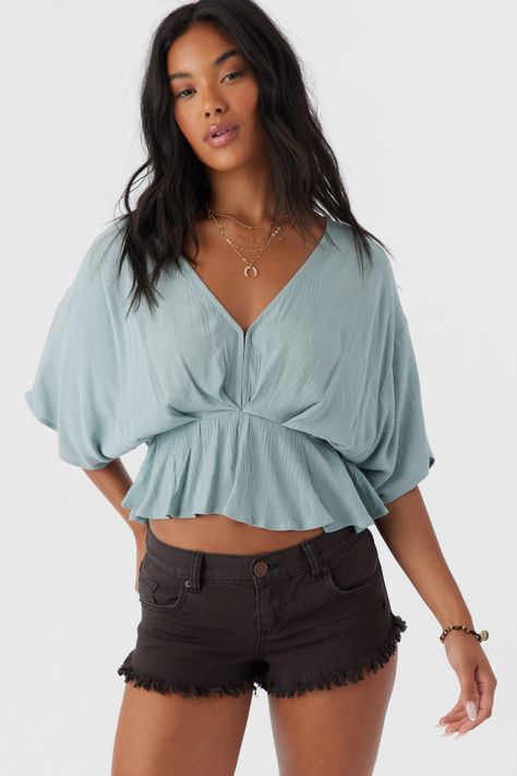 Radiate effortless style in this kimono-inspired woven top. It features a deep v-neckline with hook & eye closures, flowy fit and solid color wash. O'Neill Women's woven top Skimmer length Kimono style Peplum Waist Hook and eye closure Solid color wash 100% Viscose Crinkle | O'Neill Women's Carey Top in Silver Blue, Size Small, Viscose Summer Tops Big Bust, Flowy Top Outfit, Tops For Big Busted Women, Flowy Tops Outfit, Basic Top Outfit, Loose Top Outfit, Tops For Women Stylish, Peplum Top Outfits, Flowy Tops Summer