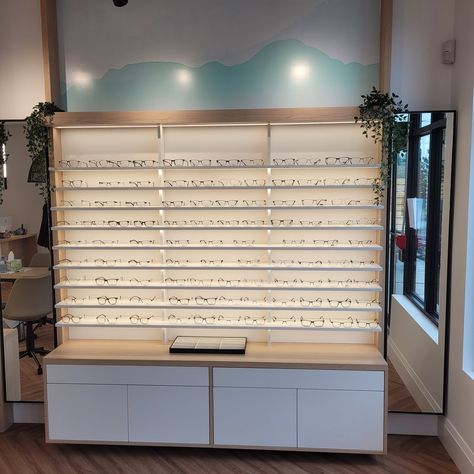 Light wood grain cabinets with white accents, perfect for eyeglass display. Illuminated by LED lights. #OptometryClinic #Optometry #EyewearShowcase #LEDLighting #InteriorDesign Wood Grain Cabinets, Eyeglass Display, Show Case, White Accents, Light Wood, Wood Grain, Led Lights, Grain, Portfolio