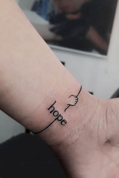 54 Bracelet Tattoos That Are Better Than Jewelry - Our Mindful Life Hand Tattoos Bracelet, Bracelet Like Tattoo, Hope Hand Tattoo, Hope Tattoos For Women Symbol, Word Bracelet Tattoo, Tattoos About Hope, Arm Wrist Tattoos For Women, Hope Tatoos Ideas, 444 Bracelet