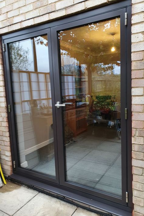 Newly fitted slimline black double glazed aluminium french doors leading out on to stone patio in Buckinghamshire. View into dining room with wooden dresser. White Brown Interior, Door Modern Design, External Glass Doors, Brown Interior Doors, Screened Deck, French Doors Patio Exterior, Black French Doors, Double Patio Doors, Aluminium French Doors