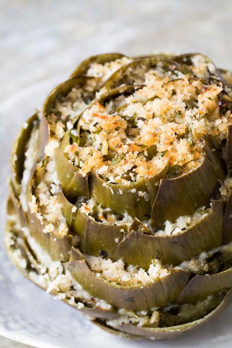 Stuffed artichokes are a perfect artichoke appetizer! Globe artichokes are trimmed and stuffed with herbed parmesan breadcrumb stuffing, then baked. On SimplyRecipes.com Artichoke Appetizer, Artichoke Recipe, Tartiflette Recipe, Stuffed Artichokes, Impressive Appetizers, Artichoke Recipes, Italian Appetizers, Easter Dinner, Samosa