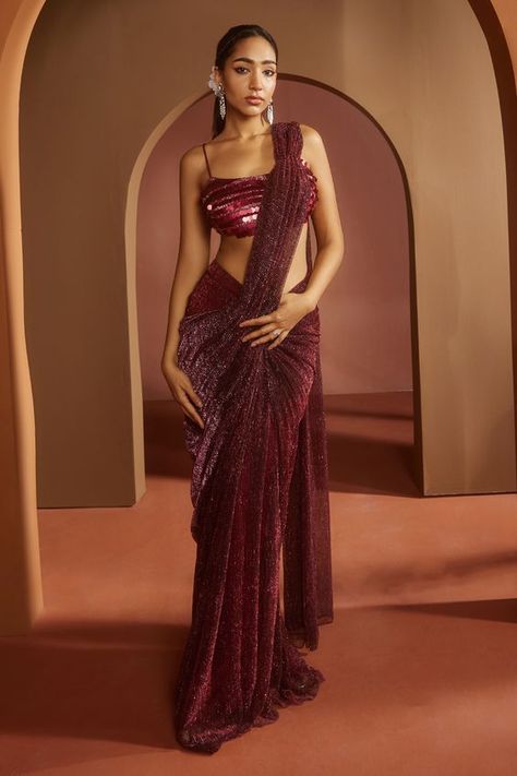 Maroon pre-draped saree in lurex. Paired with a bralette-style blouse featuring dramatic coin-like sequin all over with adjustable noodle straps. Components: 2 Pattern: Embroidered Type Of Work: Sequin Neckline: Square Sleeve Type: Sleeveless Fabric: Lurex, Satin Color: Maroon Other Details: Attached lining Model height: 5ft 9inches, wearing size S Occasion: Sangeet - Aza Fashions Indian Lehangas, Cocktail Sarees, Draped Sarees, Pre Draped Saree, Simple Dress For Girl, Sequins Saree, Maroon Saree, Draped Saree, Saree Draping Styles