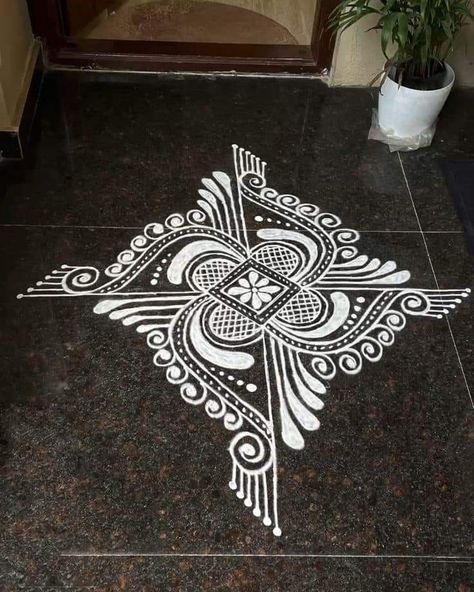 White Paint Rangoli Designs On Floor, Alpana Rangoli Design, Rangoli With Paints On Floor, White Paint Rangoli, Rangoli Design Ideas, Swastik Design Rangoli, Rangoli Designs With Paint, White Rangoli Design Simple, Painted Rangoli