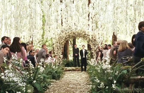 The Twilight Saga- - Breaking Dawn wedding ceremony. The ceremony featured a stunning floral canopy, made with thousands of white wisteria flowers made into 40-50 feet lengths.  At the end of the aisle there was a magnificent floral arch where Edward and Bella said their vows, covered in white flowers including delphiniums and cherry blossom. Bella Swan Wedding Dress, Bella And Edward Wedding, Breaking Dawn Wedding, Bella Y Edward, Twilight Wedding, Swan Wedding, Wedding Salon, Bella Wedding, Twilight Breaking Dawn