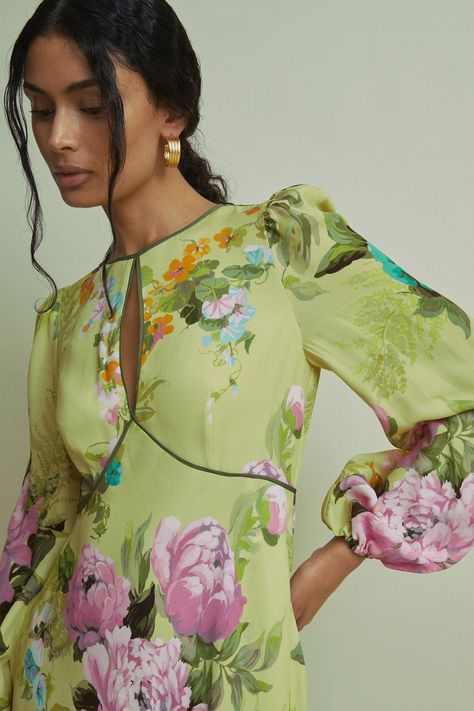 Find Florere Blouson Sleeve Midi Dress on Editorialist. The fluid fabric of this midi dress is fitted through the waist and flares at the hem. The blouson sleeves are complete with elasticated cuffs and ruffle details to the shoulder. Florere s Floral Symphony print sees painterly peonies intertwine with delicate daisies and periwinkles for a bold, enriched outlook. Keyhole opening to chest. Blouson sleeves. Elasticated cuffs. Ruffle details to shoulder. Contrast tipping. Zip-closure to reverse. Fit-and-flare silhouette. Midi length. Florere is a modern womenswear brand, that creates a distinct presence in the contemporary premium occasionwear market by inspiring women's wardrobes with bold colours, statement prints, distinctive detailing and considered versatile designs Blouson Sleeve Dress, Petite Coat, Blouson Sleeve, Swimwear Brands, Knitwear Tops, Tie Shoes, Workwear Dress, Sleeve Midi Dress, Midi Dress With Sleeves