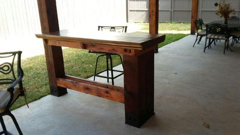 I love reinventing spaces to transform an existing area into something new. The pavilion I built in the backyard recently was a fabulous project, but it lacked one key component: a bar. That's when my wife had the idea to turn a section of the wooden deck railing into a bar top, complete with bar stools. Genius. Now we can enjoy an outdoor bar under my mini cooking pavilion. This bar top project was actually a bit more involved than I'd expected, and it required some special hardware, but once Bar Top Deck Railing, Pergola With Bar Counter, Narrow Outdoor Bar Table, Post Mounted Patio Table, Outdoor Bar Under Deck, Under Deck Bar Ideas, Deck With Bar Counter, Under Deck Bar, Pergola Bar Ideas