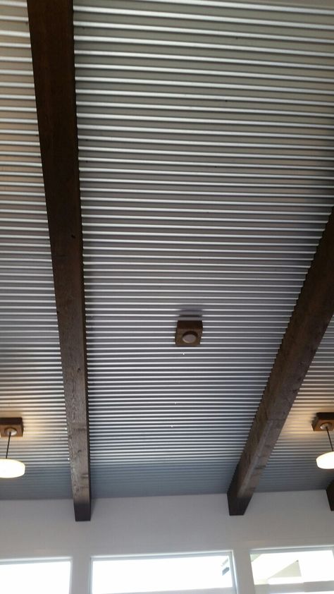 Corrugated tin ceiling with beams Painted Corrugated Metal Ceiling, Corrugated Metal Ceiling Basement, Metal Roof Interior Tin Ceilings, Metal Ceiling Ideas Corrugated Sheets, Metal Porch Ceiling, Galvanized Tin Ceiling, Metal Ceiling Ideas, Corrugated Ceiling, Corrugated Metal Ceiling