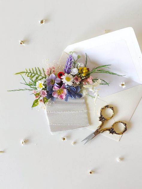 Romantic meadow flower pocket boutonniere.  The boutonniere is made of artificial and preserved flowers and other trinkets used for arranging.  SMALL BOUQUET: https://www.etsy.com/uk/listing/1676614854/small-summer-bouquet-flower-bouquet-for?click_key=32b1592cfd3cc8548476fe015f8cf4360d73029b%3A1676614854&click_sum=f0e28b1c&ref=related-4&sts=1 MEDIUM BOUQUET: https://www.etsy.com/uk/listing/1676592490/boho-summer-bouquet-bridal-flower?click_key=acba0906de9a3f98976729feac15b78aed5ef2b2%3A167659249 Spring Wedding Button Holes, Wild Flower Wedding Boutonniere, Wildflower Pocket Square, Spring Pocket Boutonniere, Wedding Flower Pocket Square, Wild Flower Button Holes, Wildflower Boutonniere Groomsmen, Flower Pocket Square Wedding, Pocket Flowers Groom