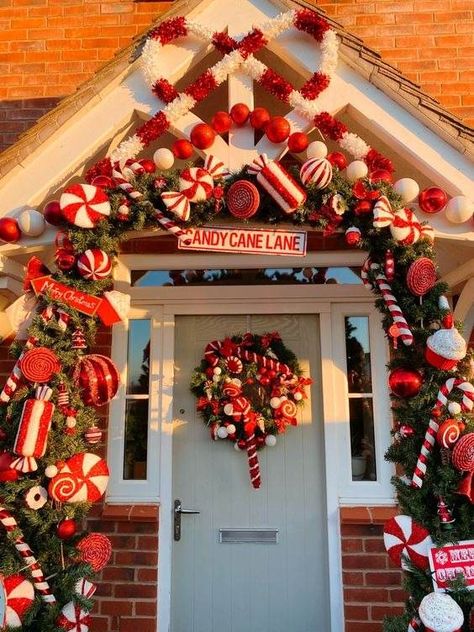 30 Gorgeous Christmas Front Porch Decoration Ideas To Wow Your Neighbors Candy Cane Theme Decorations Outdoor, Candy Cane Entryway, Candy Cane Door Garland, Outdoor Christmas Arch Ideas, Peppermint Porch Decor, Candy Cane Christmas Decorations Outdoor Front Porches, Candy Cane Christmas Outdoor Decorations, Candy Cane Lane Outdoor Decorations, Christmas Porch Archway