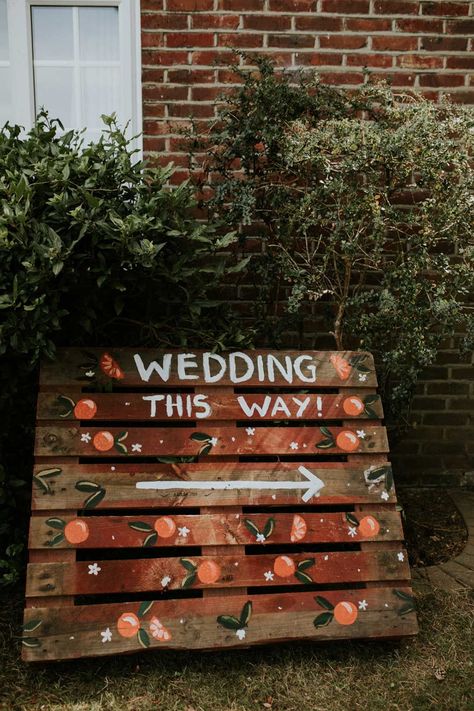 DIY wooden wedding sign with painted on wording and orange details | Heather Sham | <a href="https://www.rockmywedding.co.uk/wedding-reception-home">See more of this real wedding</a> Orange Wedding Decor, Wedding Reception At Home, Orange Wedding Decorations, Embroidered Veil, Pallet Wedding, Artificial Wedding Bouquets, Wedding Decorations On A Budget, Garden Wedding Reception, Wedding Signs Diy