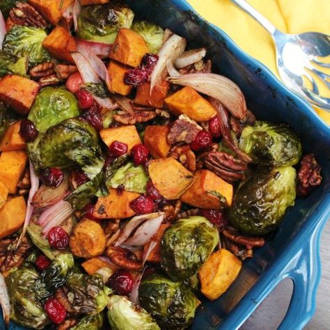 Maple Roasted Brussels Sprouts and Sweet Potatoes with Cranberries and Pecans - Brussels sprout and sweet potatoes are roasted together with cranberries, pecans, and a maple balsamic glaze, getting crispy and carmelized.  This makes for a wonderful Thanksgiving side dish or for other holidays and celebrations throughout the fall and winter! #thanksgivingsidedishes #thanksgivingrecipes #vegetariansidedishes #vegansidedishes #roastedveggies Brussel Sprouts And Sweet Potato Recipe, Brussels Sprouts And Sweet Potatoes, Sprouting Sweet Potatoes, Maple Balsamic, Thanksgiving Side Dish, Roasted Brussel, Roasted Brussels Sprouts, Sprout Recipes, Brussels Sprouts Recipe