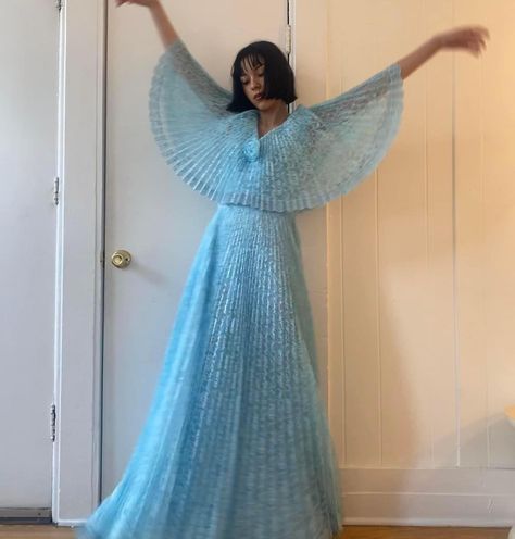 This dress is so dreamy 🤩💭✨ Thank you to Diana Martinez @apple0fureye for sharing this beauty with the group! “70s BLUE LACE CAPE DRESS! 🧚🏻‍♀️ $85 + shipping with pirate ship Absolutely stunning 70s blue lace pleated dress with a cape top and flower in the middle! The perfect spring dress, super flowy!! Would photograph beautifully! Fully lined inside with zipper in the back + hooks. Dress is in great vintage condition / no major flaws but a trip to the dry clean wouldn’t hurt! FLAT MEASU... Dress With A Cape, Diana Martinez, Cape Top, Dress With Cape, Lace Cape, Cape Tops, Blue Gown, Cape Dress, Pirate Ship