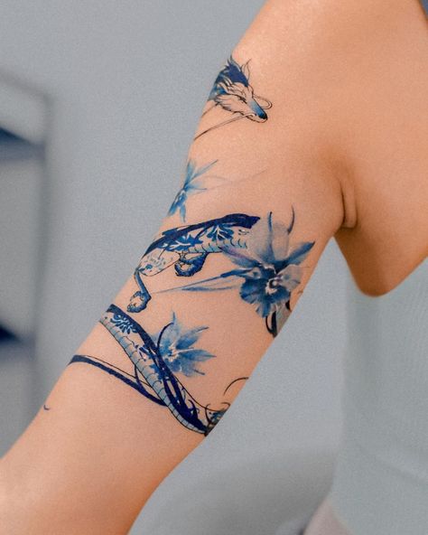 Porcelain haku and blue irises wrapped around the arm 🐉💙 Thank you :) @e.nal.tattoo @vismstudio | Instagram Blue Flower Shoulder Tattoo, Blue Arm Tattoos For Women, Blue Haku Tattoo, Blue And Orange Tattoo, Blue Shoulder Tattoo, Haiku Dragon Tattoo, Light Blue Ink Tattoo, Porcelain Blue Tattoo, Female Tattoos Leg